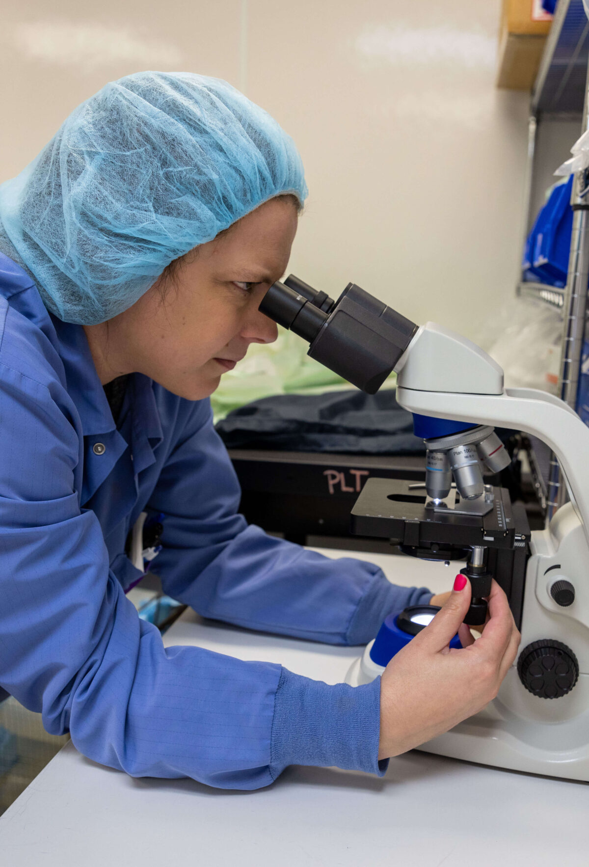 Streck employee using a microscope